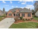 Brick house with three-car garage and landscaped yard at 412 Autumnlight Dr, Salisbury, NC 28147