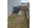 Goodman HVAC unit and trash cans in backyard at 5835 Natick Dr, Charlotte, NC 28214