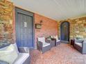 Front porch with brick flooring and wicker seating at 1116 E Franklin Blvd, Gastonia, NC 28054