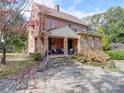 Two-story brick home with stone detailing and porch at 1116 E Franklin Blvd, Gastonia, NC 28054