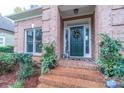 Brick front porch with a dark green door and brick steps at 17418 Sailors Watch Pl, Cornelius, NC 28031