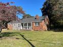 Brick ranch home, featuring a covered porch and lawn at 223 Chester Ave, Great Falls, SC 29055
