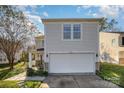 Two-story house with a white garage and small front yard at 12413 Stowe Acres Dr, Charlotte, NC 28262