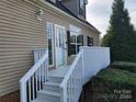 White porch with stairs leading to the front door at 129 Burning Ln, Stony Point, NC 28678