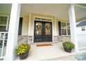 Inviting front entrance with double doors, stone accents, and seasonal decor at 6826 Forney Hill Rd, Denver, NC 28037