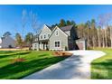 Two-story house with gray siding, white trim, and a long driveway at 1865 Rock Hill Church Rd # 3, Matthews, NC 28104