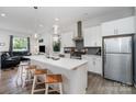 Modern kitchen with white cabinets and island at 4147 Merlane Dr, Charlotte, NC 28206