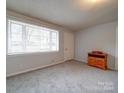 Living room with grey walls, carpeted floors and wooden console at 104 Sailers Dr, Lattimore, NC 28150