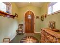 Inviting entryway with arched wood door, hardwood floors and antique furniture at 2224 Taylor Rd, Shelby, NC 28152