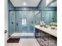 Spa-like bathroom with a large walk-in shower and blue tile at 8004 Brookbank Dr, Charlotte, NC 28269