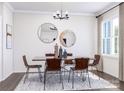 Modern dining room featuring a large table, stylish chairs, and statement mirrors at 5676 Clear Creek Ln, Charlotte, NC 28215