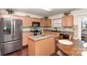 Spacious kitchen featuring island, stainless steel appliances, and hardwood floors at 9511 Eagle Feathers Dr, Charlotte, NC 28214