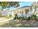 Neat yellow house with a gray brick porch and well-manicured lawn at 402 W 7Th St, Newton, NC 28658