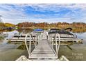 Community boat dock with multiple boats and lake access at 129 Coronilla Rd, Mooresville, NC 28117