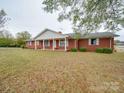 Brick ranch house with covered porch and large yard at 3113 Old Pageland Marshville Rd, Wingate, NC 28174