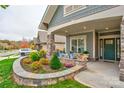 Covered front porch with stone columns and decor at 3848 Zemosa Nw Ln, Concord, NC 28027