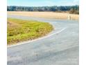 Asphalt road leads to a large, flat, open field at 5304 State Line Rd # 3, Marshville, NC 28103