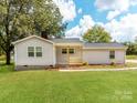 House exterior showcasing a light gray siding and a front porch at 615 Stirewalt St, China Grove, NC 28023