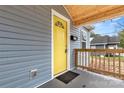 Eye-catching yellow front door with a wood-framed porch at 647 Simpson St, Rock Hill, SC 29730