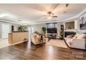 Spacious living room with hardwood floors, a fireplace, and large TV at 4511 Belmar Place Rd, Charlotte, NC 28269