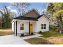 Newly built home with yellow door and small porch at 1412 10Th St, Statesville, NC 28677