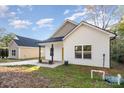 Newly built home with yellow door and small porch at 1412 10Th St, Statesville, NC 28677