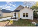 Newly built home with yellow door and small porch at 1412 10Th St, Statesville, NC 28677