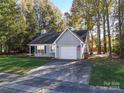 Gray sided ranch home with attached garage and American flag at 5019 Poplar Glen Dr, Matthews, NC 28104