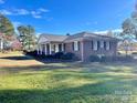 Brick ranch home showcasing side view and landscaping at 5486 Kershaw Camden Hwy, Heath Springs, SC 29058