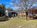 Back exterior view of home with patio and fenced area at 5486 Kershaw Camden Hwy, Heath Springs, SC 29058