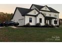 Two-story farmhouse style home with white siding and black trim at 4308 29Th Street Ne Dr, Hickory, NC 28601