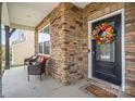 Inviting front porch with stonework and seating area, welcoming guests to the home at 12614 Chantrey Way, Huntersville, NC 28078