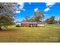 Ranch-style home situated on a spacious lot with mature trees at 4501 Taylorsville Hwy, Statesville, NC 28625