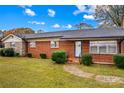Brick ranch house with a stone accent wall and well-manicured lawn at 4501 Taylorsville Hwy, Statesville, NC 28625