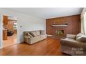 Living room features a brick fireplace and hardwood floors at 4501 Taylorsville Hwy, Statesville, NC 28625