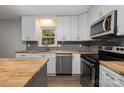 Modern kitchen featuring white shaker cabinets and stainless steel appliances at 947 Page St, Mount Pleasant, NC 28124