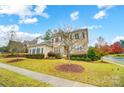 Two story brick home with a classic design and manicured lawn at 18035 Pawleys Plantation Ln, Charlotte, NC 28278