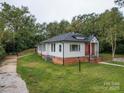 White sided home with brick base and a red door at 41 Calhoun St, Great Falls, SC 29055