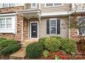 Exterior view of a townhome with stone and siding accents, landscaping, and a black door at 946 Copperstone Ln, Fort Mill, SC 29708