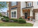 Inviting front porch with autumnal decorations at 13929 Tilesford Ln, Huntersville, NC 28078