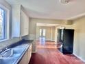 Simple kitchen with white cabinets, granite countertops, and dark wood floors at 722 Tanglewood Dr, Salisbury, NC 28144