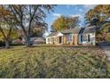 Brick ranch house with a landscaped yard and driveway at 1744 Laurel Ln, Gastonia, NC 28054