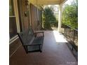 Relaxing front porch with a porch swing, perfect for enjoying the outdoors at 441 Holly Cir, Mount Holly, NC 28120