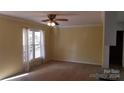 Bright living room featuring a large window and ceiling fan at 441 Holly Cir, Mount Holly, NC 28120