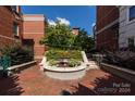 Landscaped courtyard with fountain and brick pavement at 401 N Church St # 406, Charlotte, NC 28202