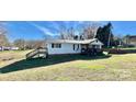 Single-wide mobile home with deck, steps, and a spacious yard at 940 Devil Track Rd, Taylorsville, NC 28681