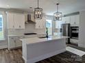 Modern kitchen featuring white cabinets, a large island, and stainless steel appliances at 2068 Fordhill St, Rock Hill, SC 29372