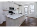 Modern kitchen with white cabinets, quartz countertops, and stainless steel appliances at 2212 Noble Townes Way, Charlotte, NC 28262