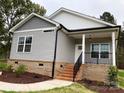 Gray sided home with brick base and a front porch at 3010 Forbes Rd, Gastonia, NC 28056