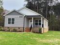 Gray sided home with brick base and a front porch at 3010 Forbes Rd, Gastonia, NC 28056